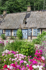 Fototapeta na wymiar charming home / charming half-timbered house with a beautiful flower garden