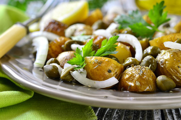 Young potato salad with capers and marinated onion.