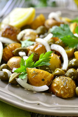 Young potato salad with capers and marinated onion.