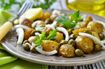 Young potato salad with capers and marinated onion.