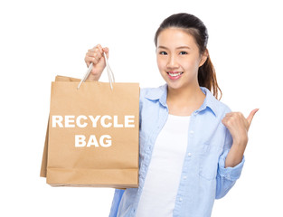 Woman with shopping bag and thumb up for showing recycle bag