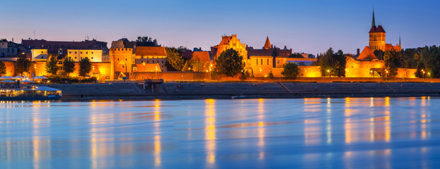 Panorama of Torun at night reflected in Vistula river, Poland - obrazy, fototapety, plakaty