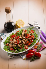 chicken salad with arugula ,tomatoes and balsamic vinegar