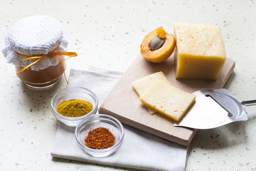 Apricot curry in a glass jar, spices and fresh apricots, selective focus