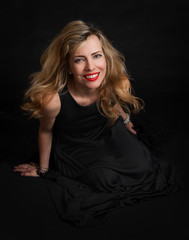 Naklejka premium beautiful sensuality woman in black dress posing