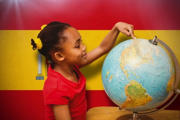 Composite image of happy pupil with globe
