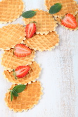 Waffles, mint and ripe strawberries.
