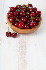 Ripe cherry in a wooden bowl