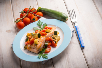 salmon with fresh tomatoes and zucchinis