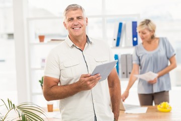 Smiling businesswoman holding a tablet