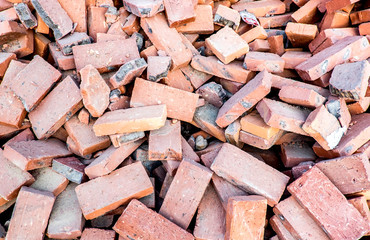 Close up pile of orange brick at construction site