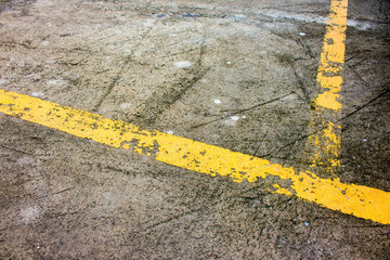 Old yellow traffic lines on the road.