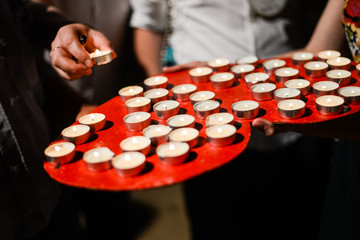 many small candles on a tray