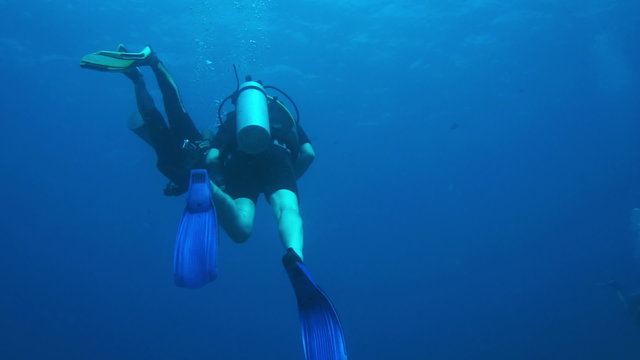 Man scuba diving trainning practice underwater with corall reef