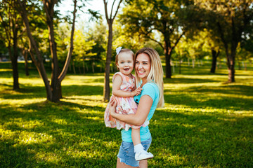 Fototapeta premium Happy mom and daughter smiling at nature.