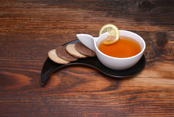  Cup of tea and crackers on wood