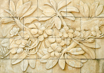 Low relief cement Thai style handcraft of plumeria or frangipani