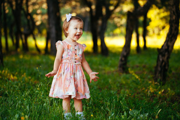 Cute little girl on the meadow in summer day.