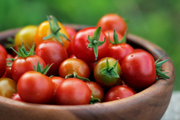 Ripe Cherry tomatoes in a wooden plate
