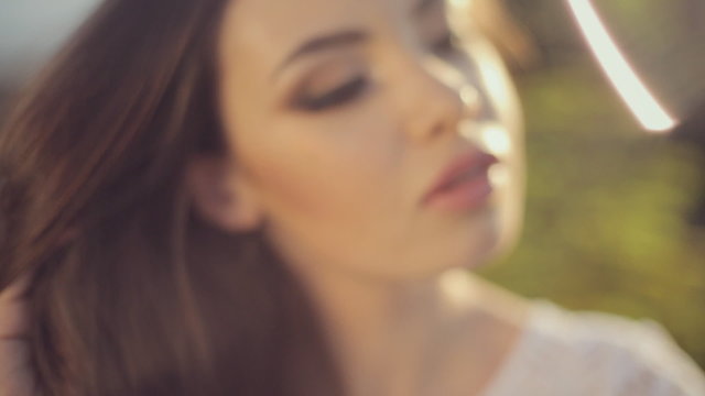 Charming girls in a white tank top posing on nature