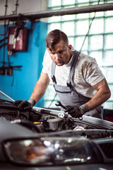 Car mechanic with wrench