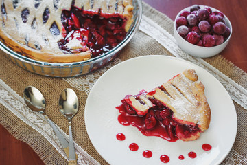 Slice of friut pie with cherries