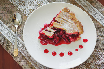 Slice of friut pie with cherries