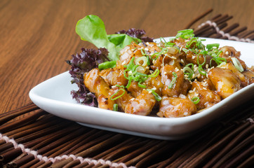 japanese cuisine. fry sauce chicken on the background