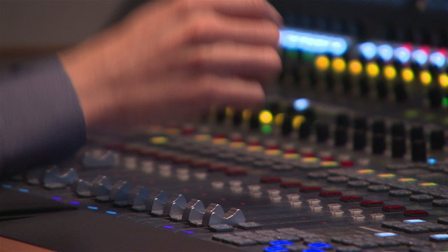 Sound editor works with the sound mixer during live broadcast on TV.
