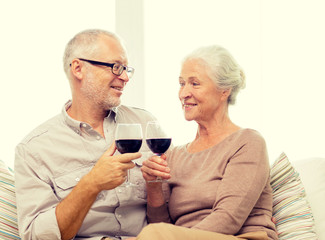 happy senior couple with glasses of red wine