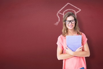 Composite image of pretty geeky hipster holding notepad