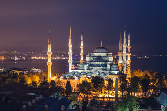 Istanbul, the Blue Mosque at sunset, as seen from an elevated position behind the mosque the illuminated city