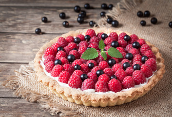Raspberry tart pie with whipped cream, blackberry and mint - obrazy, fototapety, plakaty