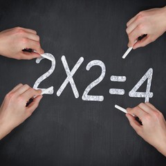 Composite image of multiple hands writing with chalk