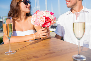 smiling couple drinking champagne at cafe