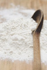 Flour with old wooden spoon