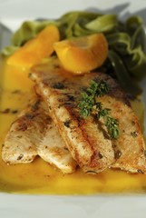 Hare fillet with apricots and green ribbon pasta (close-up)