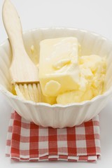 Melting butter with pastry brush in dish