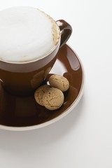 Cup of cappuccino and amaretti