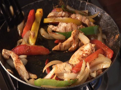 Cooking vegetables and chicken breast fillet in frying pan