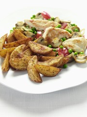 Potato wedges with chicken breast and vegetables