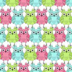 Seamless pattern of colorful owls on a white background