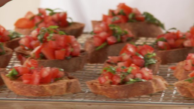 Bruschetta being sprinkled with pepper