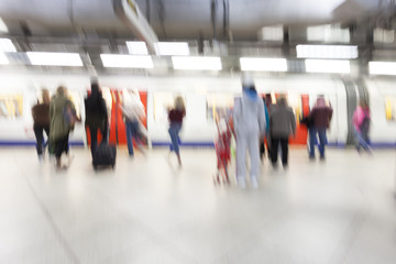 People standing and waiting in subway station, motion blur, zoom