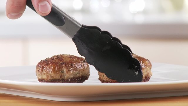 Meatballs being arranged on a plate