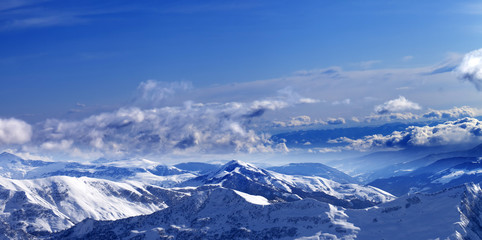 Fototapeta na wymiar Panoramic view on sunlight snowy mountains