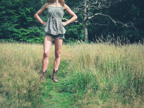 Young woman standing in meadow