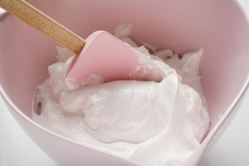 Meringue with a spatula in a mixing bowl