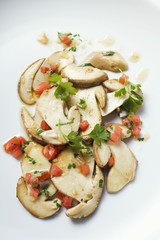 Fried porcini mushrooms with diced tomatoes and parsley
