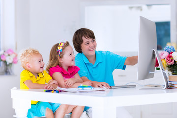 Kids doing homework with modern computer